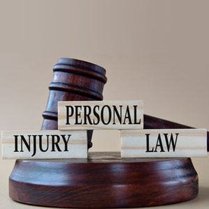 Wooden gavel with blocks displaying 'Personal Injury Law' in front.