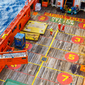 Top view of workers in safety gear on a marked cargo deck symbolizing maritime injury claim